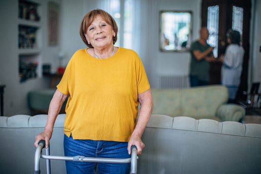 Portrait of happy senior woman in the nursing home with mobility walker occupational therapy for adults