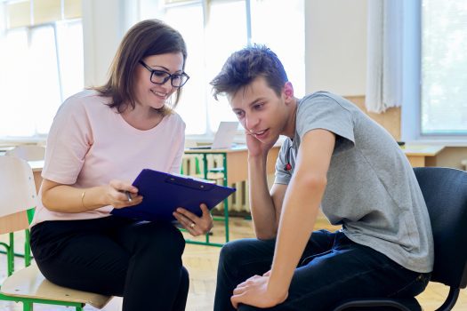 Female NDIS support worker assisting NDIS young male participant