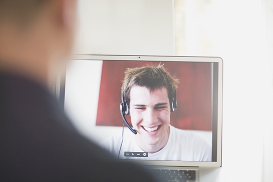 Teenagers talking on laptop with NDIS occupational therapist video chat