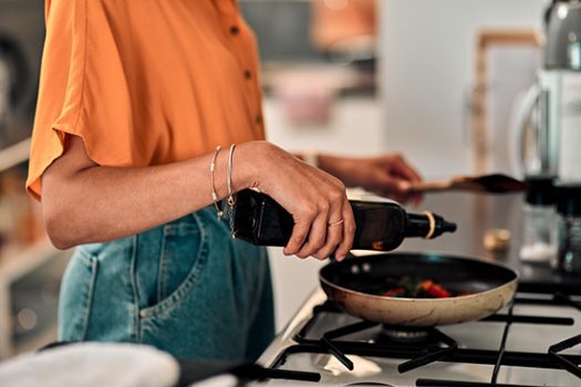 Cropped shot of a young woman preparing a healthy meal at home positive behaviour support strategies