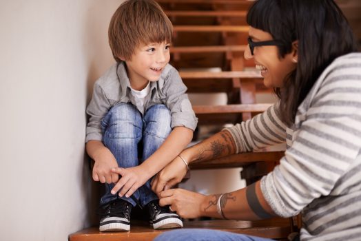 NDIS occupational therapist supporting child with tying shoelaces