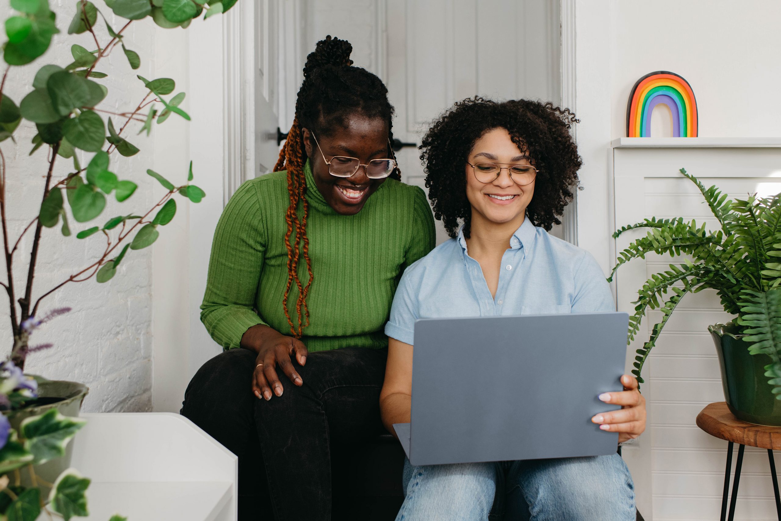 Allied health practitioner and patient looking at something on a laptop