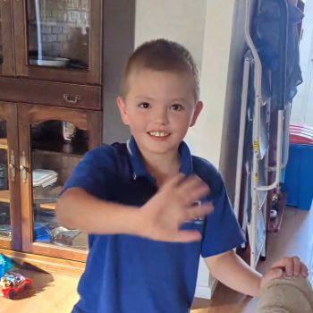 Axel smiling and waving