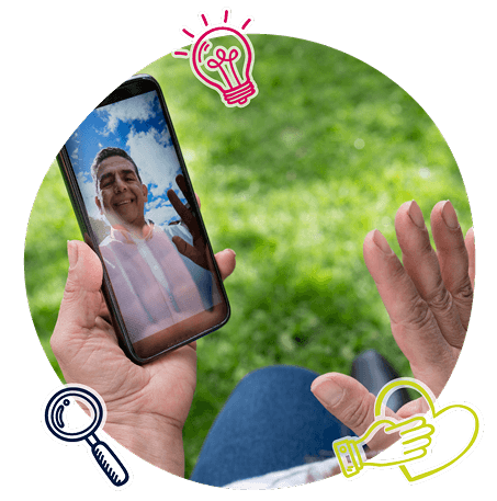 A person waving time a person via video call on a mobile device