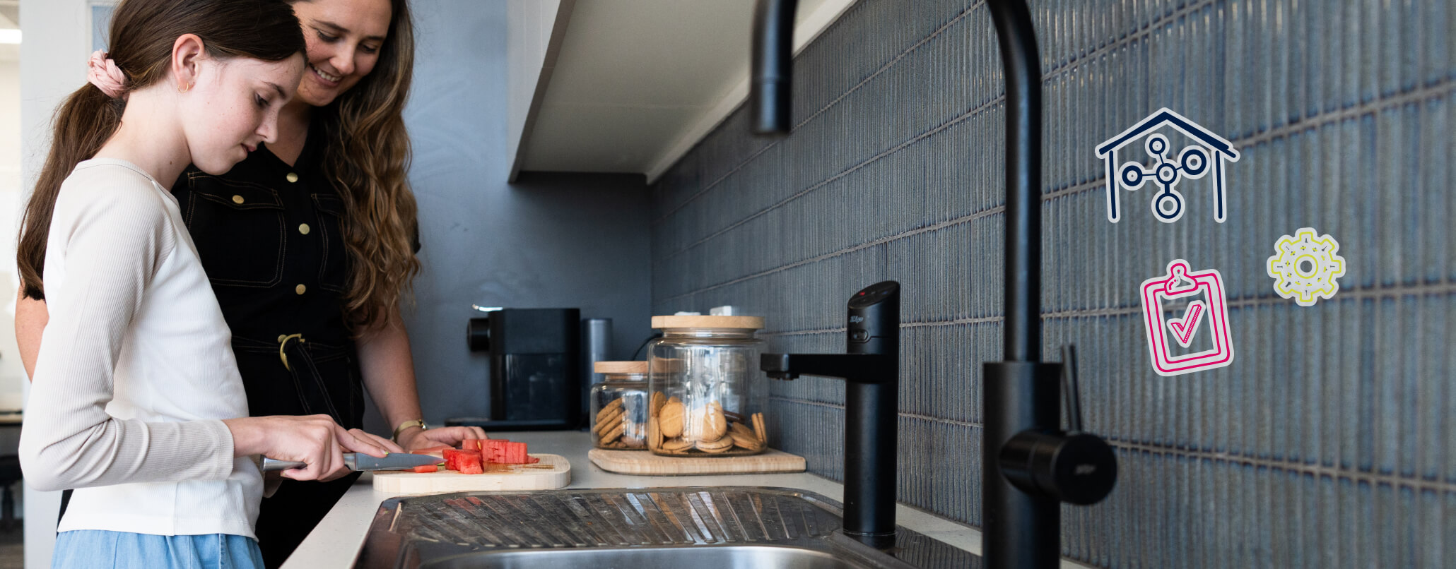 A girl cutting watermelon. A woman is observing, smiling