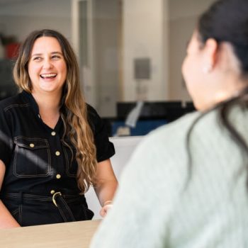 Two women, smiling and laughing together
